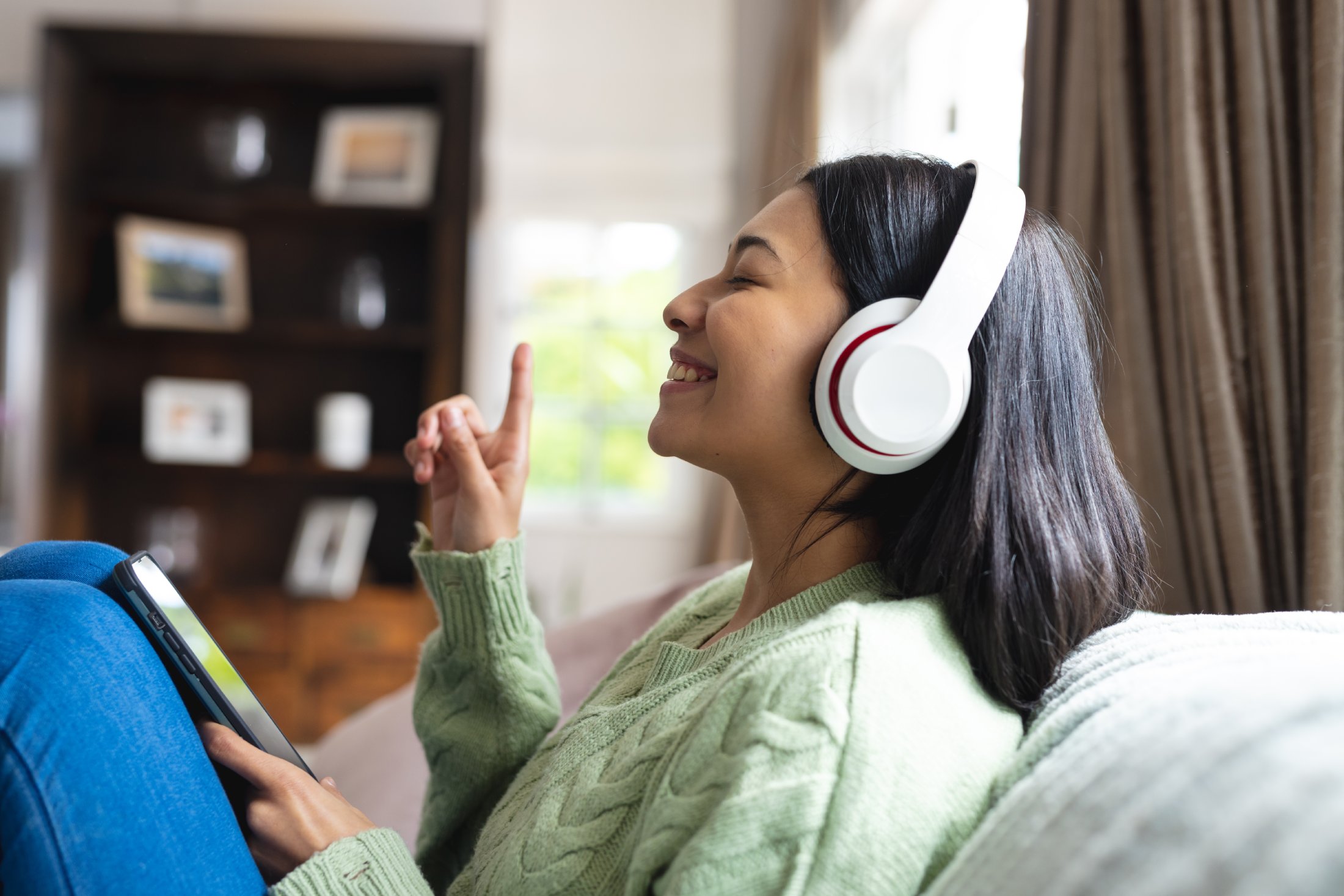 Woman enjoying an audiobook memoir
