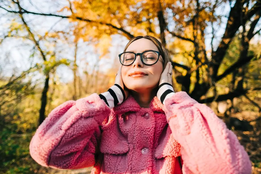 On a sunny autumn day, woman listens to the Fall 2026 issue of CML